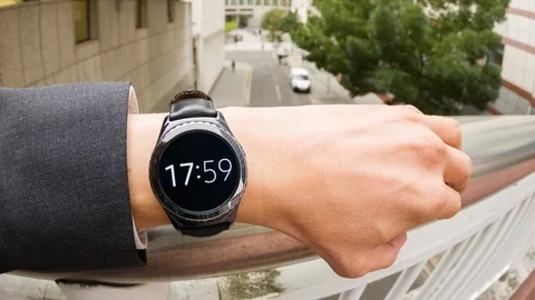 Businessman checking the time on a smartwatch Stock Footage 104047400