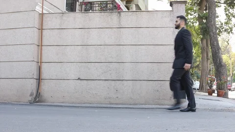 Businessman checking time while walking in office building Stock Footage 113615046