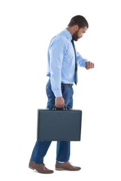 Businessman checking time while walking against white background Stock Photos