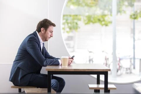 Businessman checking using smartphone in a caf 写真素材