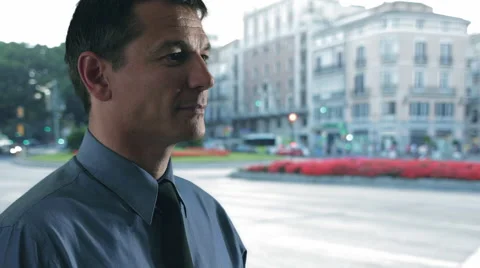 Businessman checks watch, while standing on street. Stock Footage 43679837