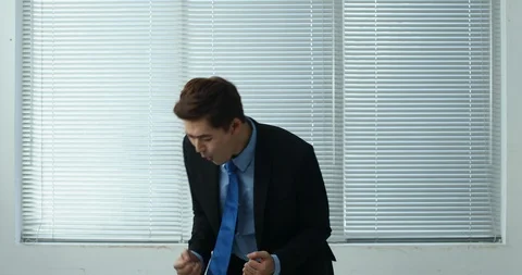 Businessman cheering at the window Stock Footage 100950269