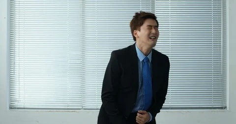 Businessman cheering at the window Stock Footage 100950306