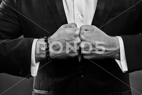 Businessman clenching fists, hidden aggression concept. Man in smart suit and Stock Photos