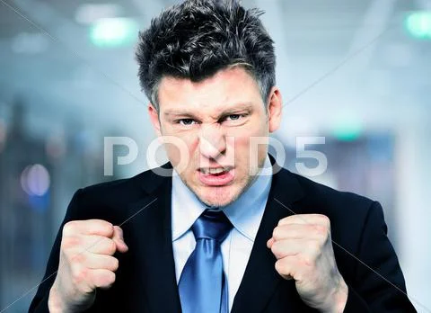 Businessman Clenching Fists To Motivate Team In Office Stock Photos