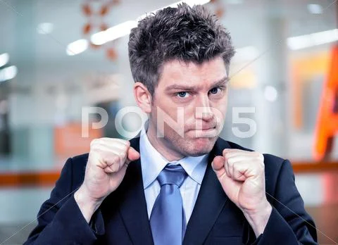 Businessman Clenching Fists To Motivate Team In Office Stock Photos