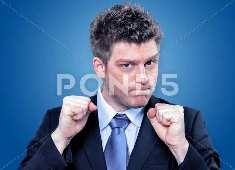 Businessman Clenching Fists To Motivate Team In Office Stock Photos