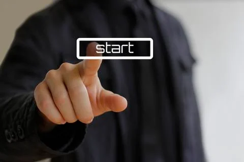 Businessman clicks on the start button Stock-Fotos