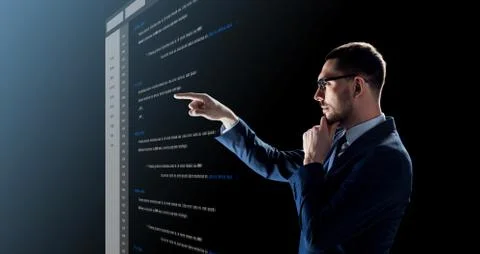 Businessman with coding on virtual screen Stock Photos