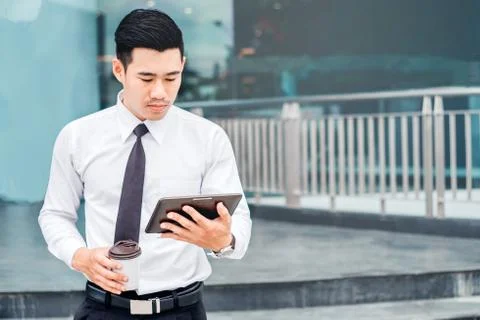 Businessman  With Coffee Using Digital Tablet at city outside office Stock Photos