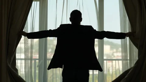 Businessman come to window and quickly open dark curtains, bright sunny Stock Footage 86483077