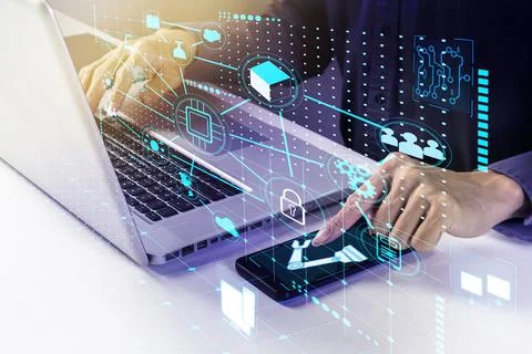 A businessman commands a robot via a computer or mobile device.,The electroni Stock Photos