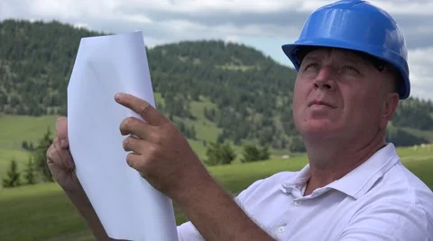 Businessman Company Engineer Looking on Plan Draw Verifying  Site Emplacement. Stock Footage 67419093