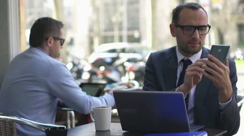 Businessman comparing data between a laptop and in a cellphone Stock Footage 38685293