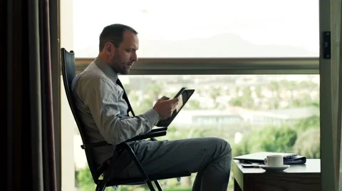 Businessman comparing data on tablet computer and smartphone HD Stock Footage 48705054