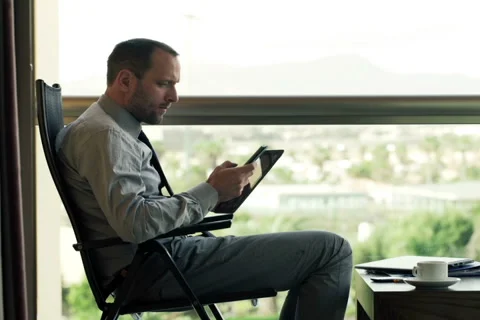 Businessman comparing data on tablet computer and smartphone NTSC Stock Footage 48705071