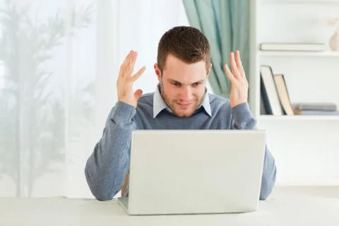 Businessman with computer problems in his homeoffice Stock Photos