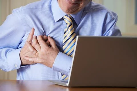 Businessman At Computer Suffering Heart Attack Stock Photos