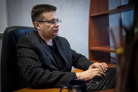 Businessman concentrating on computer work, looking at laptop screen, thinkin Stock Photos