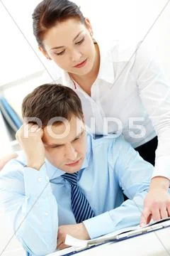 Businessman concentrating while looking at working plan at meeting Stock Photos