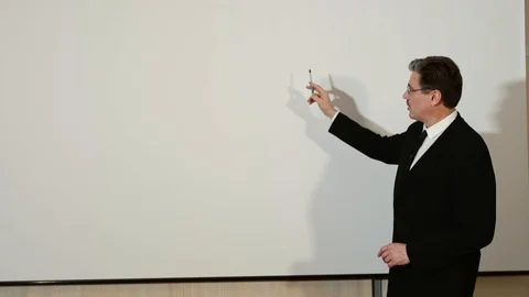 Businessman conducts a presentation of project on a white board background. Stock-Footage 101970310