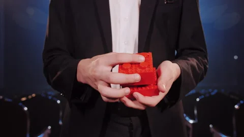 Businessman Connecting Two Red Building Blocks as Business Synergy Concept Video stock 336197836