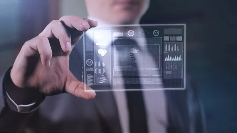Businessman considers infographic on the panel of the future. 動画素材 119359097