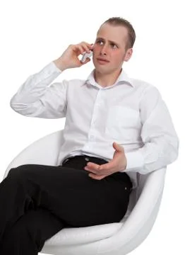 A businessman in a conversation on the phone solves the problem Stock Photos