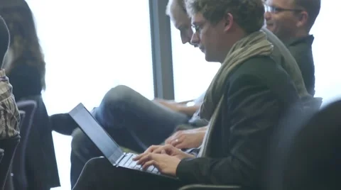Businessman at a corporate event typing notes on his laptop Stock Footage 64566202