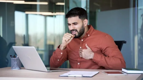 Businessman coughing while sitting at workplace in a business office. Sick with  Stock-Footage 320618414