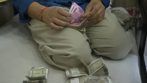 A businessman counting bundle of 2000 India rupee banknotes, Stack of cash Stock Footage 251863327
