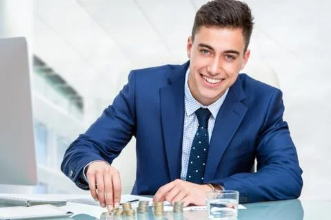 Businessman counting money at desk. Stock Photos