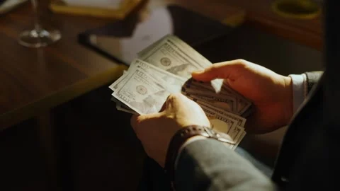 Businessman counting stack of cash inside luxury restaurant during business.. Stock Footage 337605449