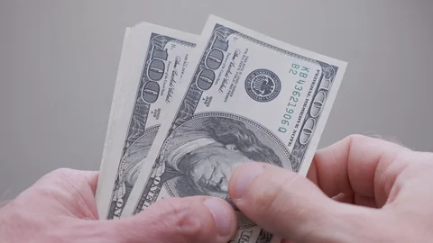Businessman counts dollars and throwing them on the mirror table Stock Footage 106228734