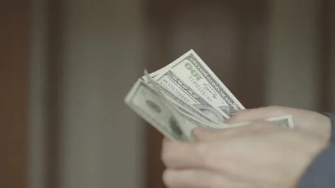 Businessman counts dollars in hands. close-up shot. Stock Footage 133123407