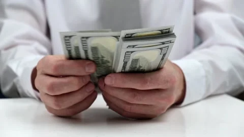 A businessman counts a stack of cash hundred-dollar bills of the USA. close-up. Stock Footage 183438747