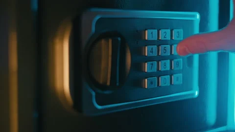 A businessman is dialing secret code. Secure password. Strongbox with pile of Stock Footage 212467836