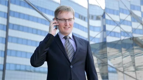 Businessman dials the phone number and talking on the phone Stock Footage