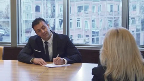 Businessman diligently writes notes during a crucial meeting Stock Footage 311992809