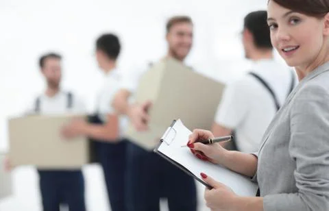 Businessman with documents, creating a stack of cardboard boxes. 写真素材