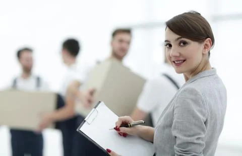 Businessman with documents, creating a stack of cardboard boxes. 写真素材