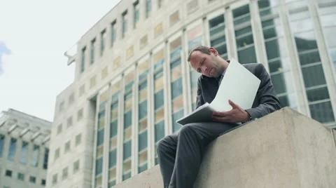 Businessman with documents talking on mobile phone in the city HD Stock Footage 11497981