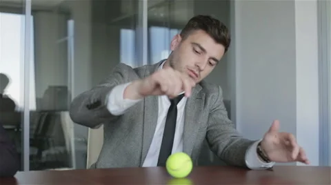 The businessman does not want to work. Man dreams of tennis during a work time. Stock Footage 63884704