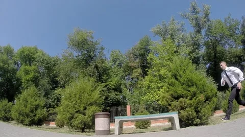 Businessman Doing a flip on a bench 库存影片 67343251