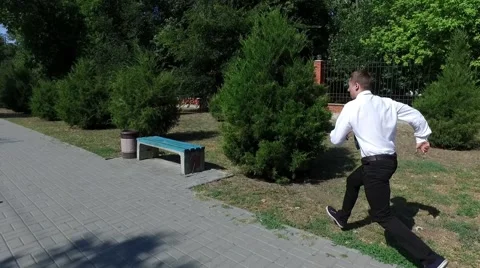 Businessman Doing a flip in a park Stock Footage 67343755