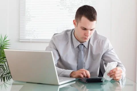 Businessman doing his calculation Stock Photos