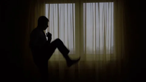 Businessman doing karate moves at the window Stock Footage 69771953