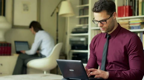 Businessman doing serious look to the camera and working on laptop Stock-Footage 51735222