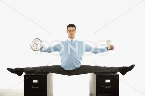 Businessman doing split across two filing cabinets Stock Photos