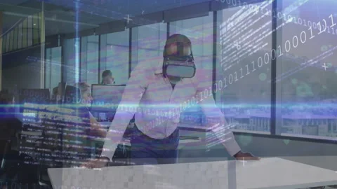 Businessman donning VR headset scanning table and demonstrating data streams in Stock Footage 314453856